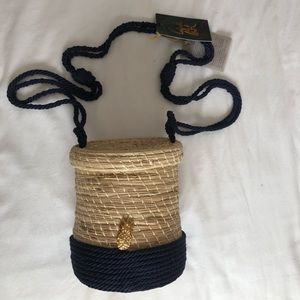 Cylinder straw bag with navy cord details.